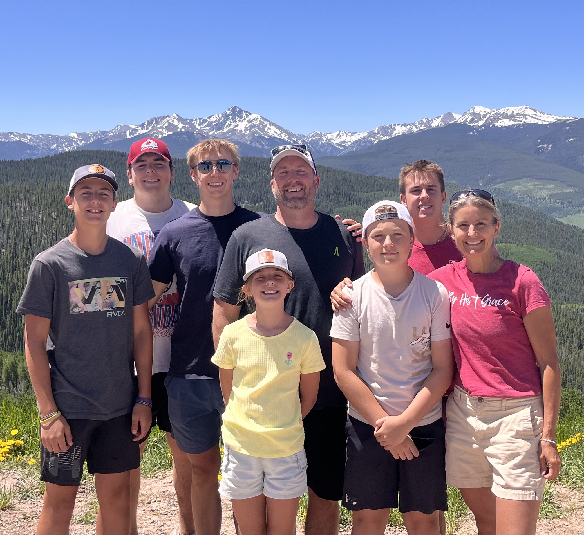 A family in front of a skyline of mountains